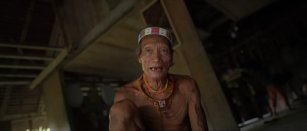 Portrait d'un jeune Mentawai tatoué avec bandeau rouge dans la forêt tropicale de Siberut île Mentawai Indonésie